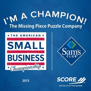 May include: A blue graphic with the text "I'M A CHAMPION!" and "The Missing Piece Puzzle Company." It also features the words "THE AMERICAN SMALL BUSINESS Championship" and the Sam's Club logo. The year 2015 is displayed.