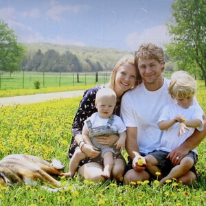 custom puzzle with 60 pieces of the family of four sitting in a field of dandelions.  The dog is sleeping.  This puzzle gift for the puzzle fan is from The Missing Piece Puzzle Company