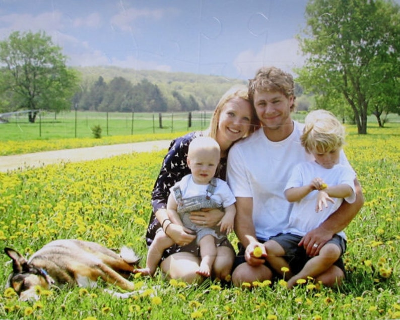 custom puzzle with 60 pieces of the family of four sitting in a field of dandelions.  The dog is sleeping.  This puzzle gift for the puzzle fan is from The Missing Piece Puzzle Company