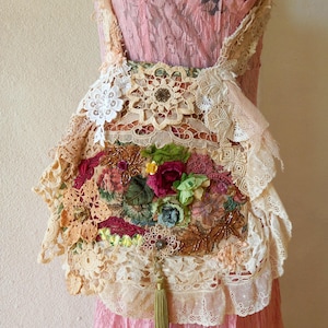 Boho Cross body bag.Lush Layered vintage laces,doilies,tapestry ,vintage buttons with many details .Floral motifs and a tassel