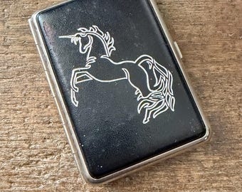 Vintage cigarette case with silver colored unicorn black leatherette facing panels