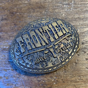 Vintage Frontier Hotel Las Vegas Nevada brass colored oval belt buckle