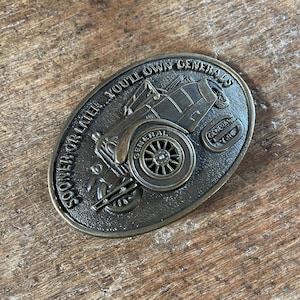 Vintage General Tire automotive advertising brass colored belt buckle