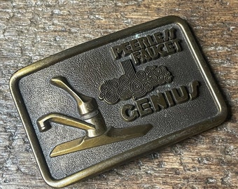 Vintage Peerless Faucet Genius advertisement brass colored belt buckle