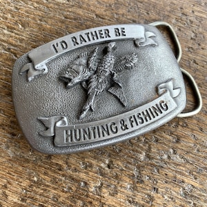 Vintage I’d Rather Be Hunting & Fishing Fish and Game Bird raised design oval pewter colored belt buckle