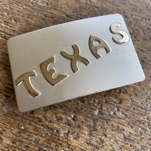 Vintage buckle Texas raised letter design pewter amd chrome colored belt buckle