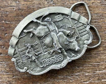 Vintage Buckle Cowboys Rodeo Bull Riding figural Western themed brassy pewter colored belt buckle Bergamot
