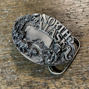 Vintage North to Alaska Dogsled and Gold miner themed scene pewter colored belt buckle