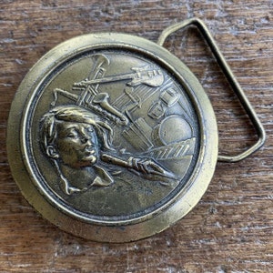 Vintage buckle musician Singer Figural Brass colored raised design belt buckle 1977