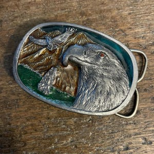 Vintage belt buckle Flying Eagle and head with enameled wilderness background raised design pewter colored belt buckle 1996 Made in USA