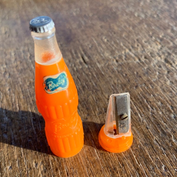 Vintage Bireley Soda Orange Bottle shaped Pencil Sharpener. Some rubbing and wear