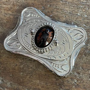 Vintage black and brown colored cabochon western style silver chrome colored belt buckle