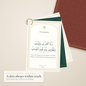 May include: A set of rectangular cards bound by a gold metal ring. The top card features the text 'For my parents', Arabic calligraphy, and the English translation: 'Our Lord, forgive me, my parents and all the believers on the Day the reckoning takes place.'