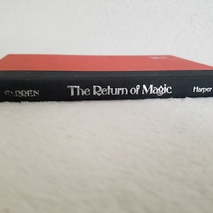 May include: A black hardcover book with a red spine. The title "The Return of Magic" is printed in silver on the front cover, along with the author's name "Farren" and the publisher "Harper & Row".