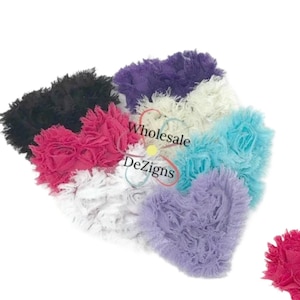 May include: A collection of ruffled fabric hearts in various colors, including black, pink, purple, white, and blue. The image also features two individual hearts, one pink and one purple. The text "3" Shabby Hearts" is displayed at the bottom.