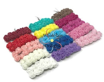 May include: Assortment of 12 colors of small foam rose flower heads. Each flower head is approximately 1 inch in diameter. The flower heads are arranged in rows, with each row containing a different color. The colors include red, pink, white, blue, purple, yellow, green, orange, brown, and black.