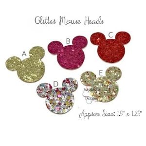 May include: Glitter Mouse Heads in various colors, including gold, pink, and red. The shapes are approximately 1.5 inches by 1.25 inches. The image includes the text "Glitter Mouse Heads" and "Wholesale Dezigns".