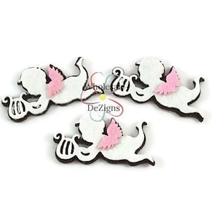 May include: Three white cherub-shaped felt appliques with pink wings and black outlines. Each cherub is in a different pose, with a musical instrument. The text "Wholesale DeZigns" is visible.