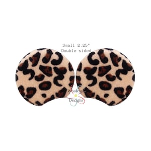 May include: A pair of 2.25 inch double-sided leopard print fabric ear patches. The patches are beige with brown spots.