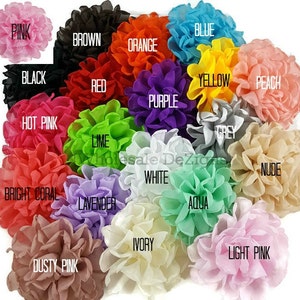 May include: A collection of colorful fabric flower embellishments in various shades, including pink, blue, orange, and purple. Each flower is labeled with its color name, such as "Pink," "Blue," and "Orange." The text "Wholesale Dezigns" is also visible.
