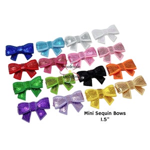 May include: Assortment of 1.5 inch mini sequin bows in various colors, including red, green, blue, purple, pink, orange, yellow, white, and black.  Mini Sequin Bows 1.5"
