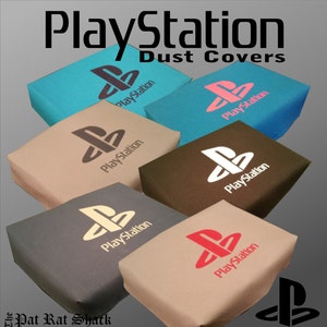 May include: A selection of PlayStation dust covers in shades like teal, pink, and beige. Each cover displays the PlayStation logo and the word "PlayStation". Designed to fit the psone ps1 SCPH-101.