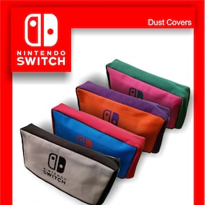 May include: A selection of Nintendo Switch dust covers in a range of colours. The covers are in grey, blue, orange, purple, pink, and green. Each cover features the Nintendo Switch logo.