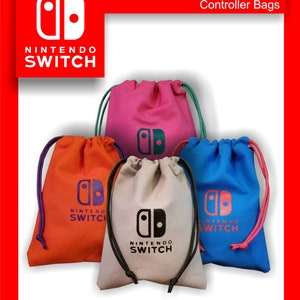 May include: A collection of drawstring controller bags in various colors: orange, pink, blue, and beige. Each bag features the Nintendo Switch logo and text. The bags have colored drawstrings, and the text "Controller Bags" is visible.