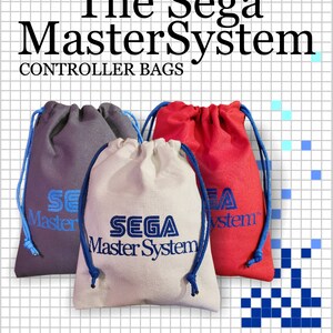 May include: Three drawstring bags in grey, beige, and red, each featuring blue drawstrings and the blue embroidered text "SEGA Master System". The bags are displayed against a white grid background with the text "The Sega MasterSystem CONTROLLER BAGS".