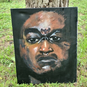 May include: A close-up portrait painting of a person with dark skin. The person has a serious expression and is looking directly at the viewer. The painting is done in a realistic style and features a dark background.