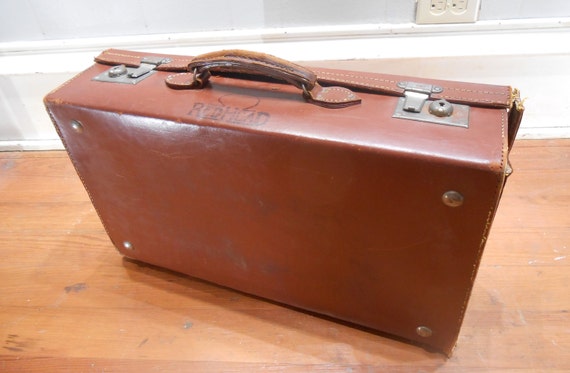 vintage leather suitcase with straps