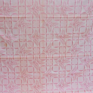 May include: Pink fabric with a repeating pattern of stylized floral sprigs in a grid pattern.