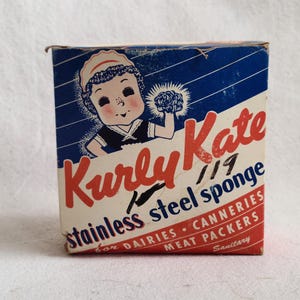 May include: A vintage box of "Kurly Kate" stainless steel sponges. The box features a cartoon girl holding a sponge and the text "for Dairies, Canneries, Meat Packers, Sanitary".