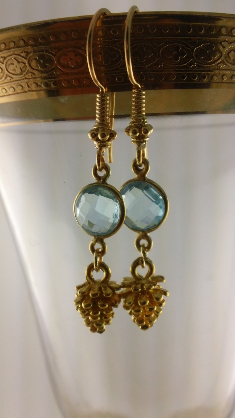 Bezeled sky blue topaz Pine Cone II Faceted Sky Blue Topaz and Pine Cone in vermeiil dangle