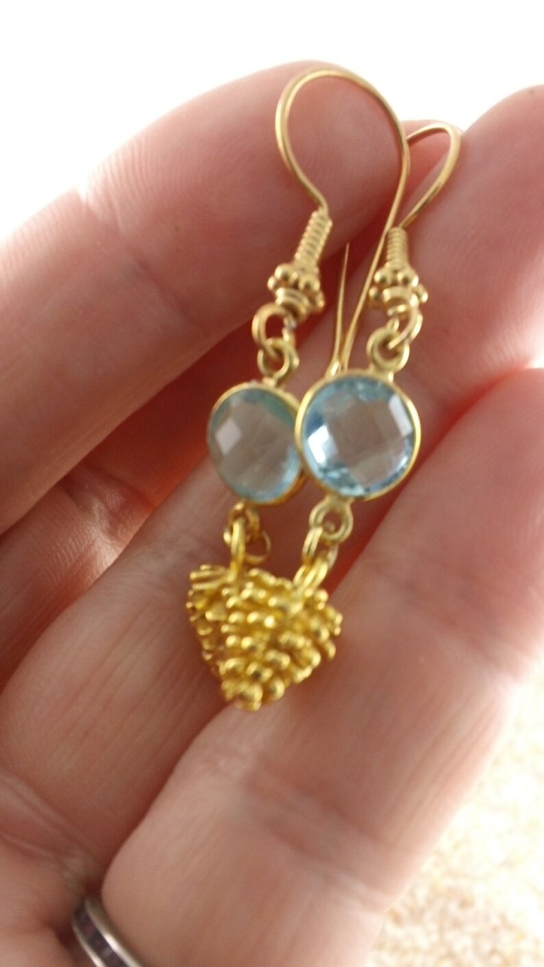 Bezeled sky blue topaz Pine Cone II Faceted Sky Blue Topaz and Pine Cone in vermeiil dangle