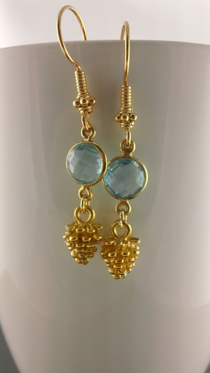 Bezeled sky blue topaz Pine Cone II Faceted Sky Blue Topaz and Pine Cone in vermeiil dangle