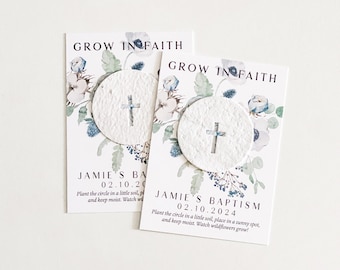 May include: Two white cards with blue and green floral designs. Each card has a small white circle with a cross on it. The text on the cards reads "Grow in Faith" and "Jamie's Baptism 02.10.2024".