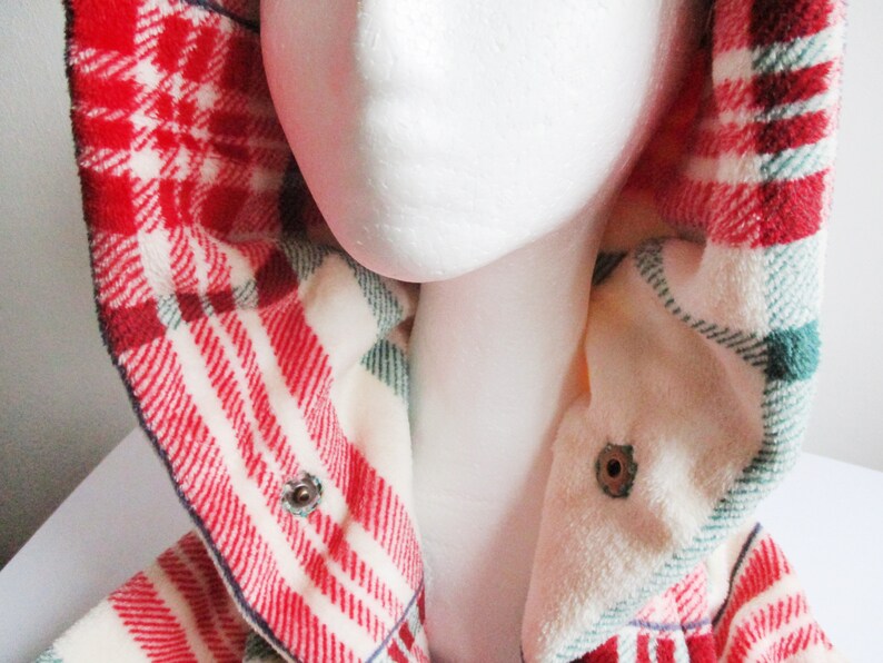 May include: Red and white checked flannel shirt with a green and white checked lining. The shirt has a hood and a button fastening.