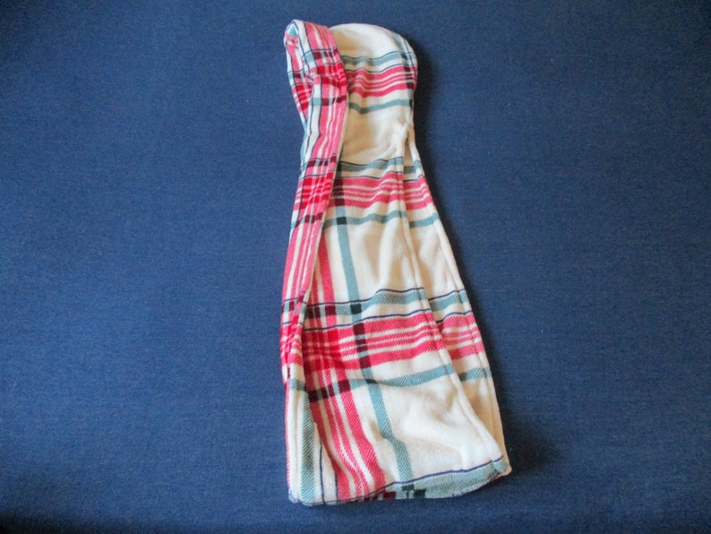 May include: A white hooded towel with a red, blue and white plaid pattern.