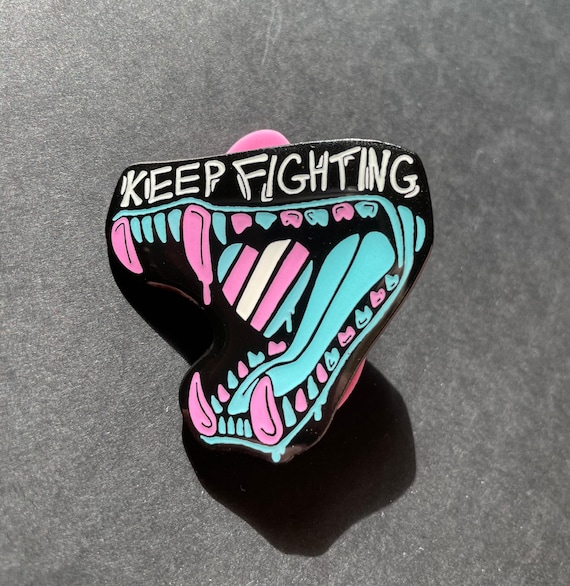Keep Fighting trans pride pin