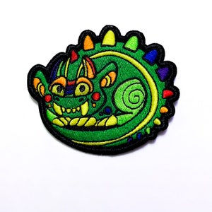 May include: A green, rainbow-colored, embroidered patch of a curled-up dragon with a toothy grin.