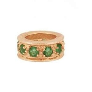 May include: A gold ring with a band of green gemstones.