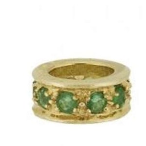 May include: A gold ring with a band of emerald green gemstones.