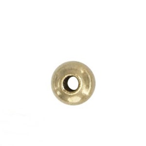 May include: A single gold-colored round bead with a hole in the center.