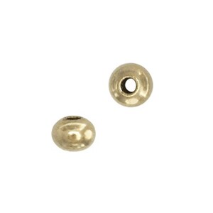 May include: Two gold-colored metal beads with a hole in the center.