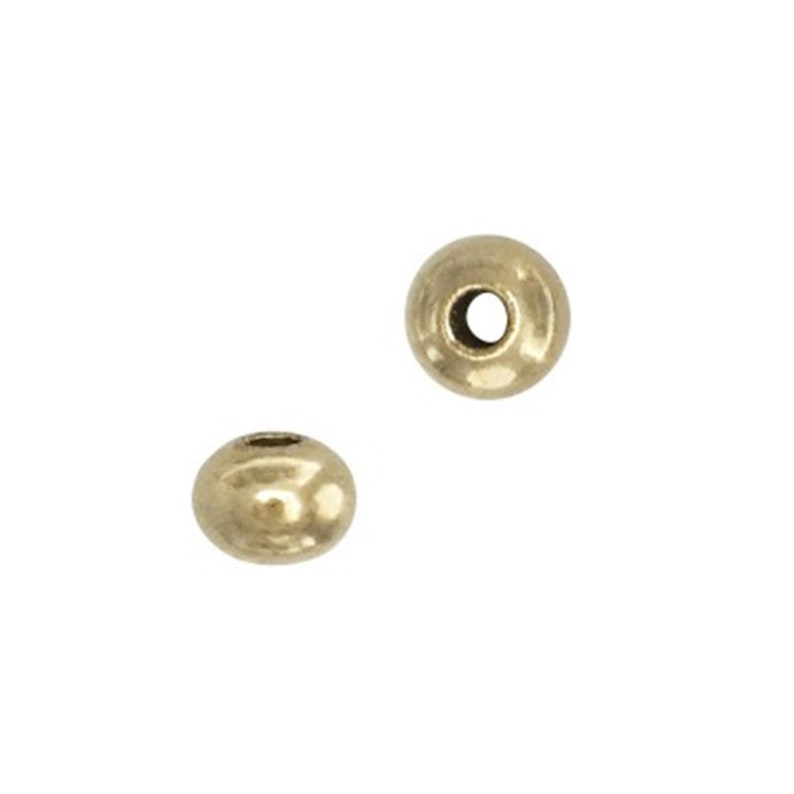 May include: Two gold-colored metal beads with a hole in the center.