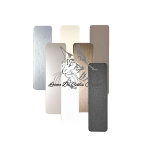May include: A set of six wood veneer samples in various colors and textures. The samples are arranged vertically and include silver, beige, white, wood grain, brown, and gray.