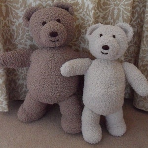May include: Two plush teddy bears, one brown and one beige, standing side by side. Both bears have black eyes and a black nose.