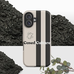 May include: A phone case featuring a vertical black stripe on a beige background. The text Cased Culture is printed in black and white, accompanied by a small graphic icon of a falling phone with motion lines and a puff of dust.