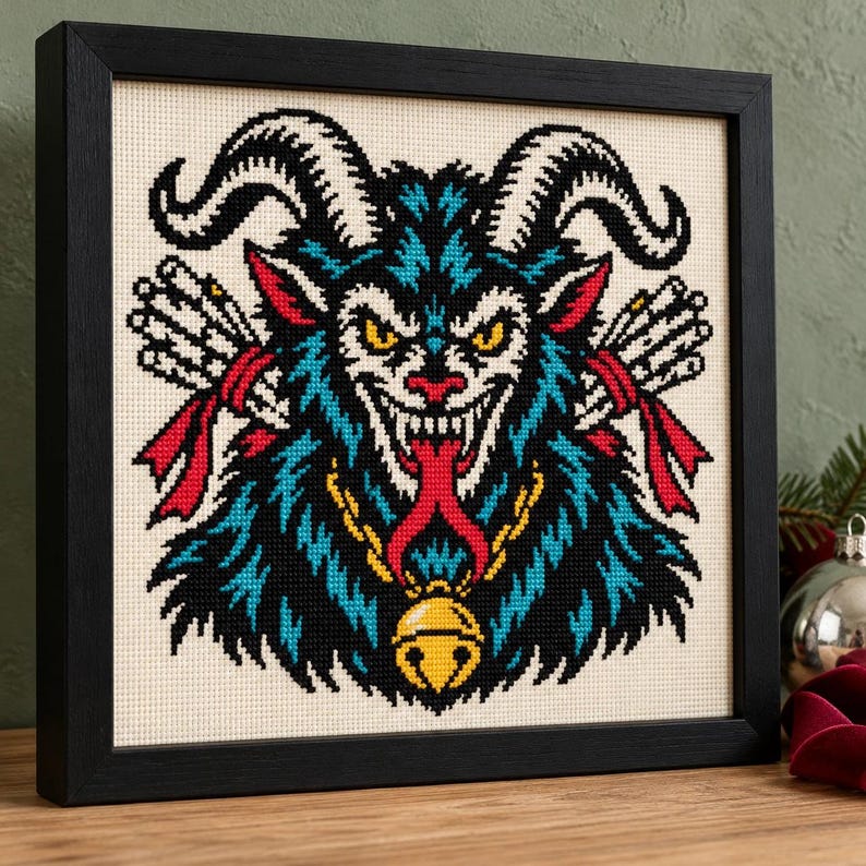 Krampus cross stitch in a black frame on a shelf